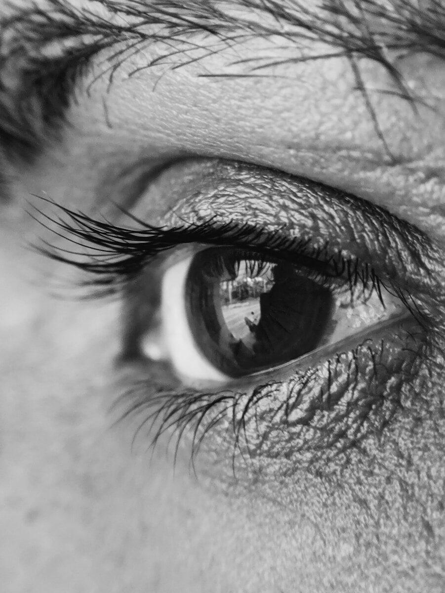 grayscale photography of person's eye